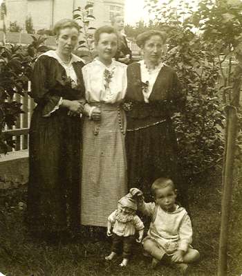 imagen antigua de una familia posando en el patio trasero con un gnomo de jardín